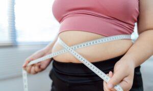 A woman measures her belly and wonders how to get semaglutide for weight loss.
